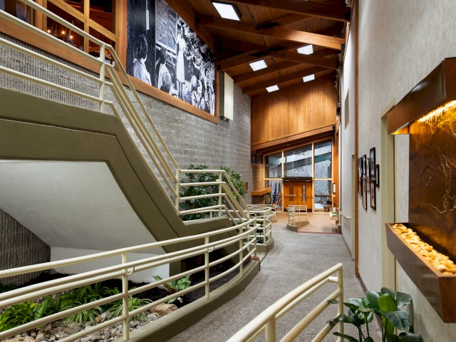 Elegant interior with staircase, wood paneling, and artistic decor.