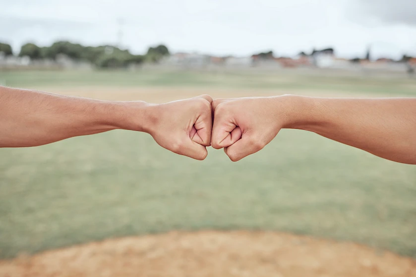 Two fists bumping together in a gesture of camaraderie or greeting.