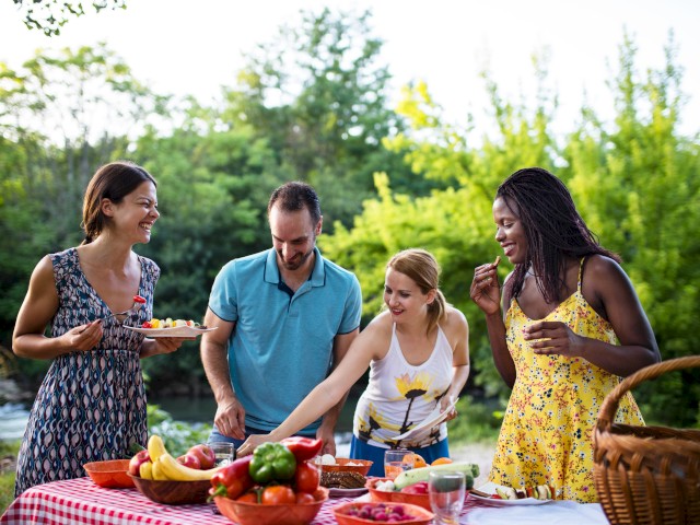 People talking and making plates for buffet table